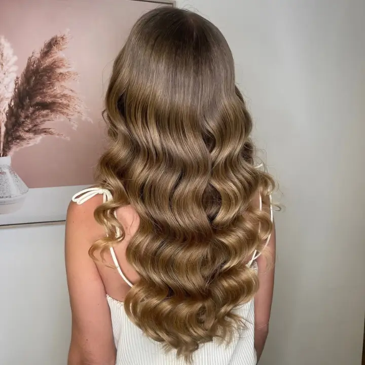 Long wavy blonde hair styled at Astair Organic Hair