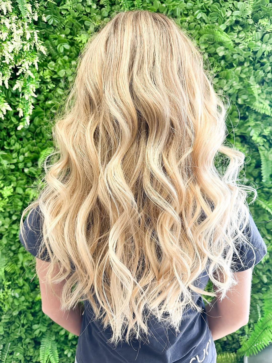 Blonde balayage styled into soft waves